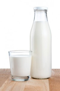 Bottle of fresh milk and glass is wooden table Isolated on white background